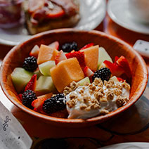Ensalada de Frutas with honey, granola, and yogurt